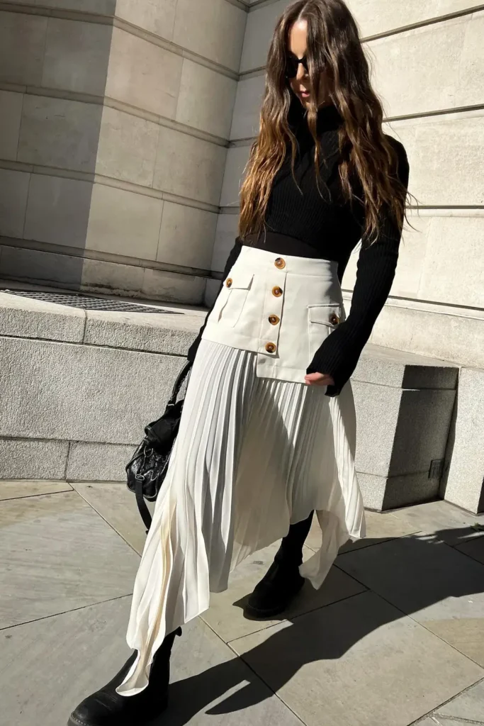 Black Ribbed Turtleneck and a Cream Pleated Skirt With Boots