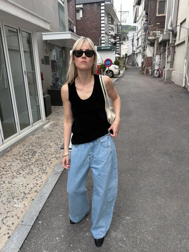 A Black Velvety Tank With Pale Seamed Jeans