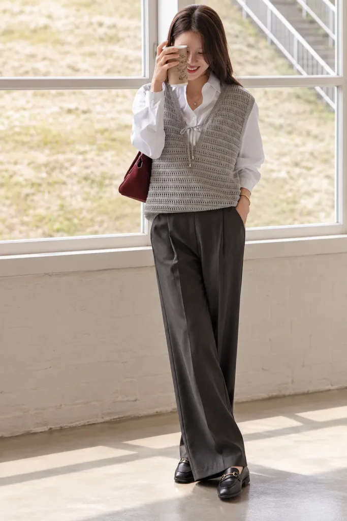 A Gray Knit Vest Over a White Shirt