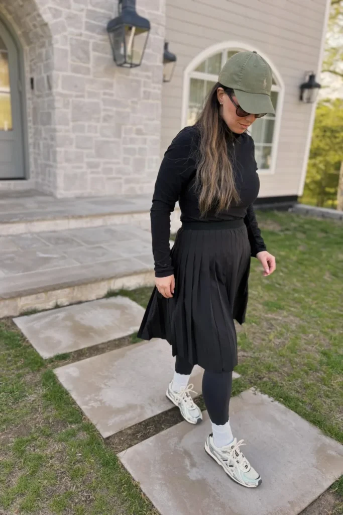 Black Pleated Skirt Over Leggings With Sneakers