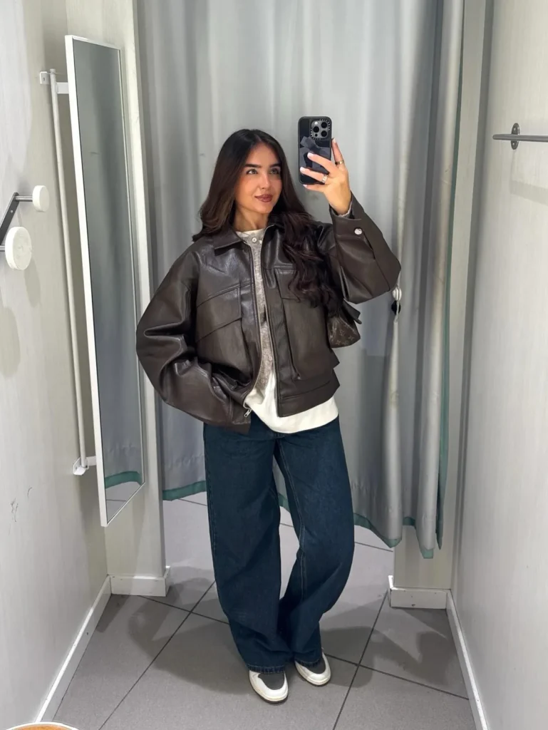 A Brown Leather Jacket Layered Over a Gray Cardigan