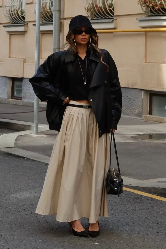 Leather Bomber Jacket Over a Beige Pleated Maxi Skirt