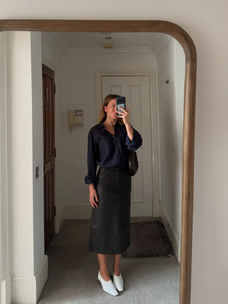 A Navy Shirt Tucked Into a Black Leather Midi Skirt