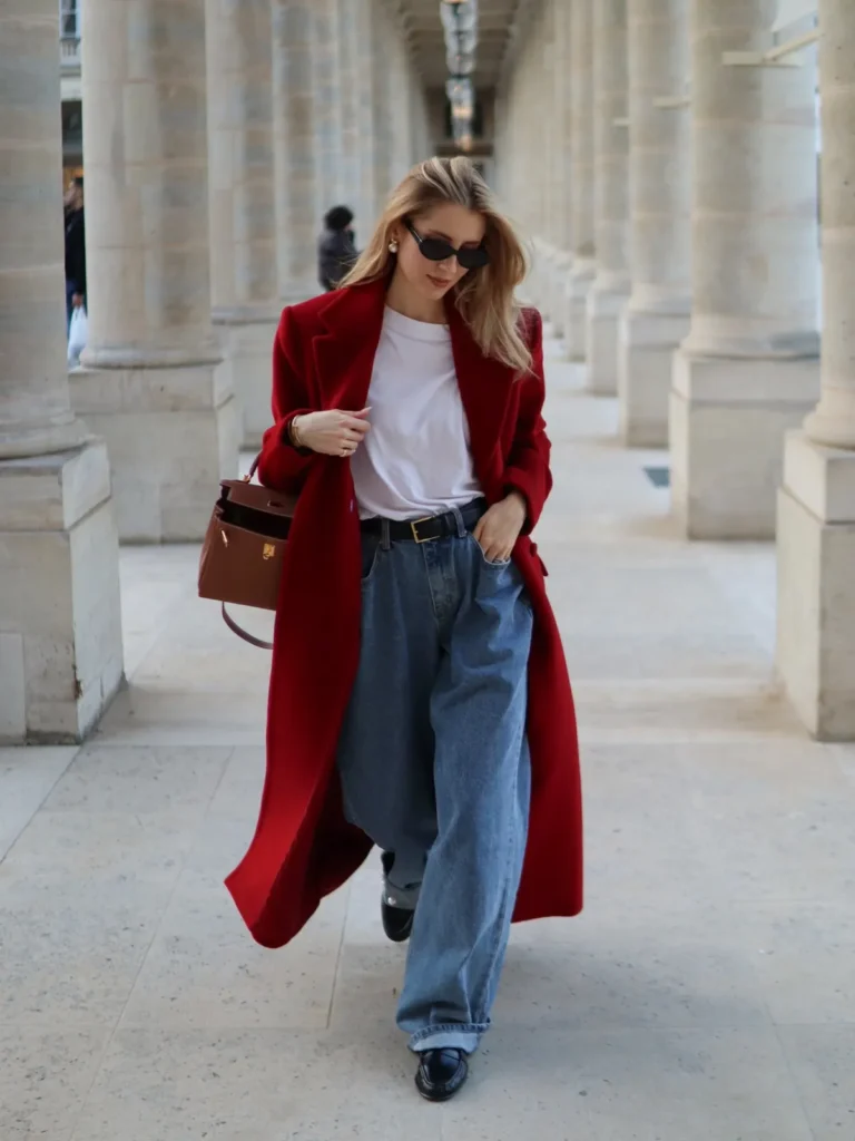 A Long Red Coat Over a White Tee and Belted Jeans