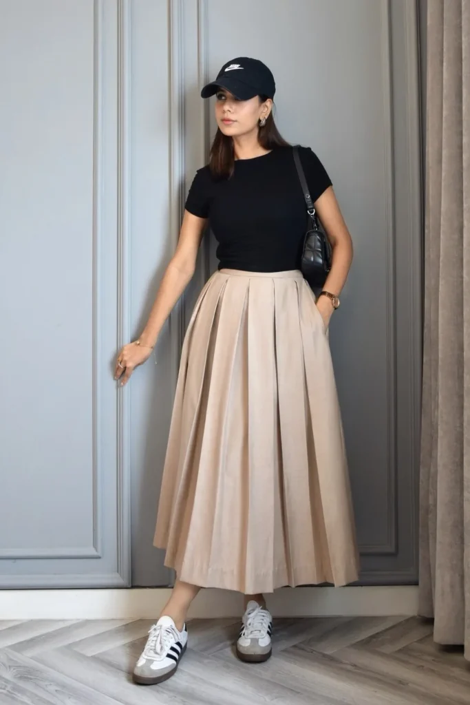A Business Casual Pleated Skirt Outfit With a Black Tee