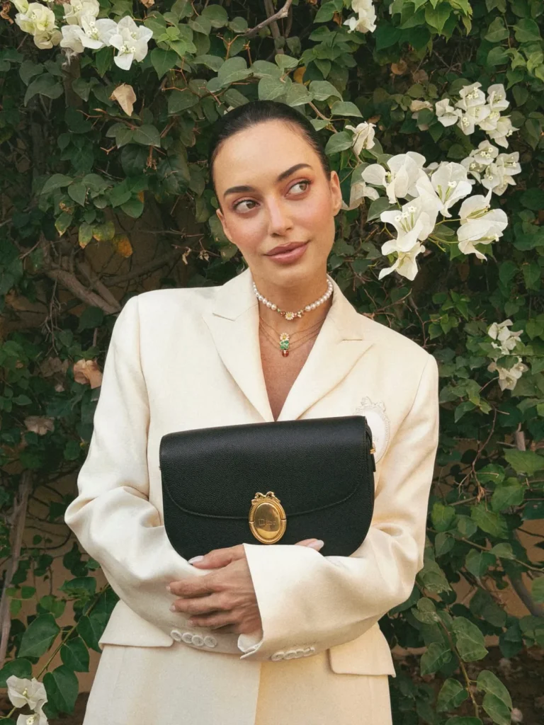 A Cream Blazer With Playful Necklaces