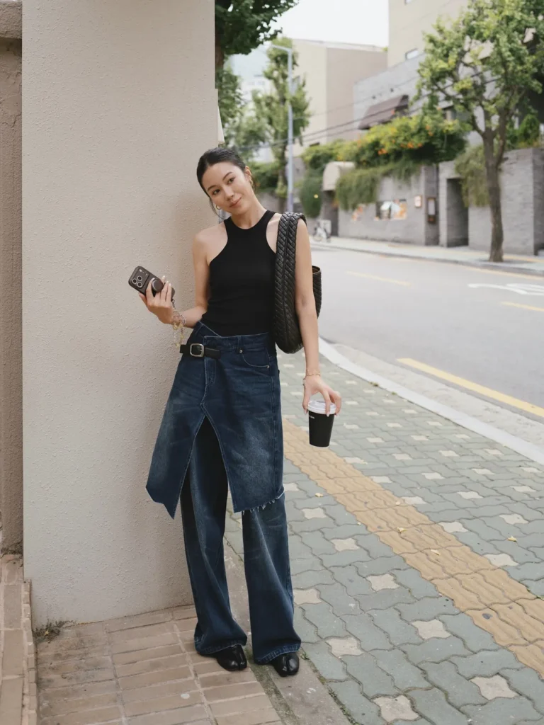 A Denim Skirt Panel Layered Over Wide Leg Jeans