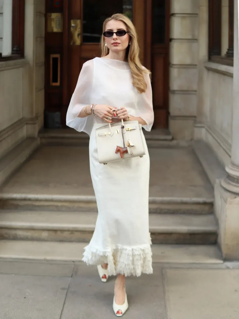 A Sheer Cape Top With a Fringe Hem Skirt