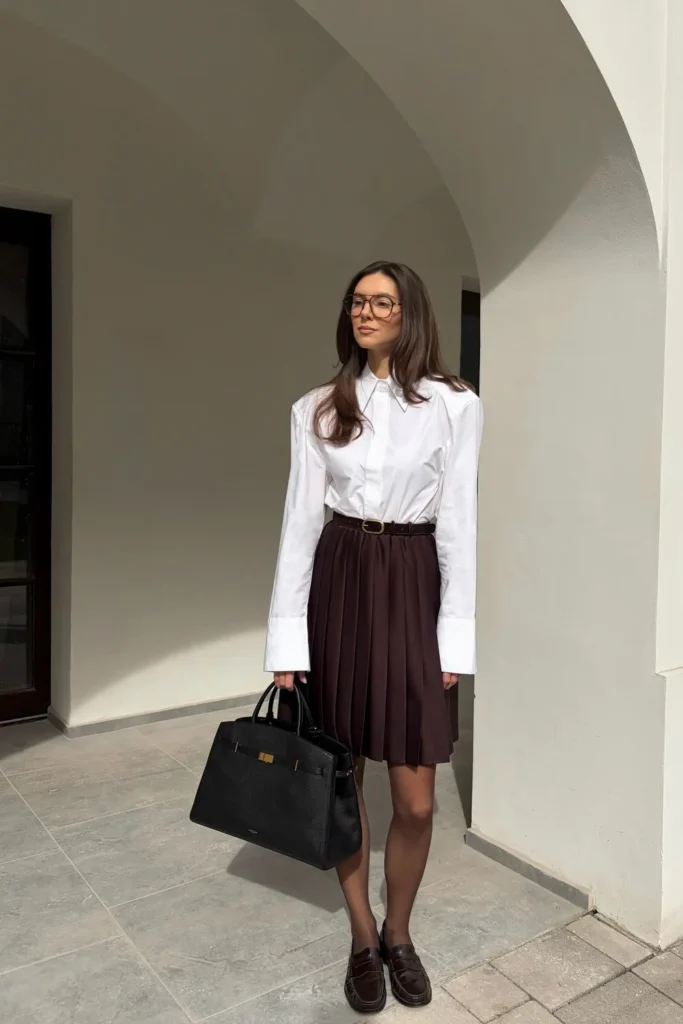 Pleated Mini Skirt With a White Shirt, Tights, and Loafers