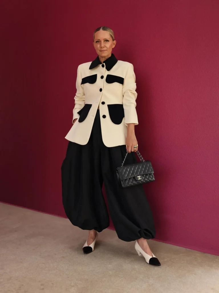 A Cream Jacket With Black Velvet Trim and Balloon Trousers