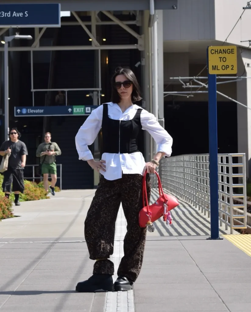 A Black Corset Top Over a White Shirt With Leopard Trousers