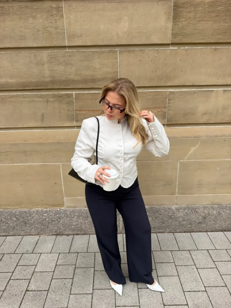 A Cream Button Front Jacket With Navy Trousers