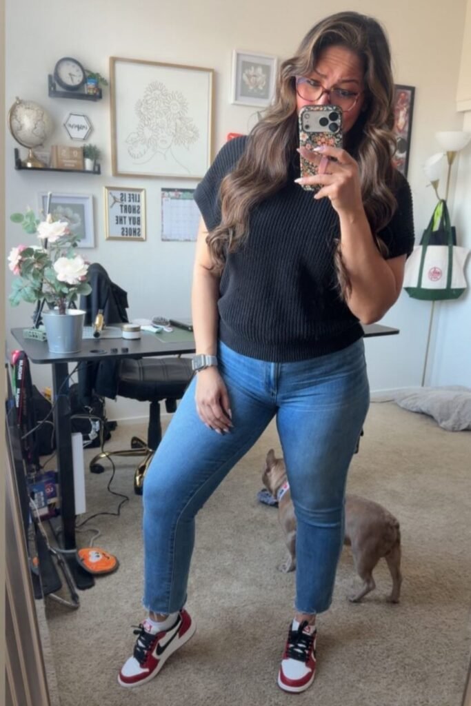 A Ribbed Black Knit Tee With Straight Jeans and Red High Tops