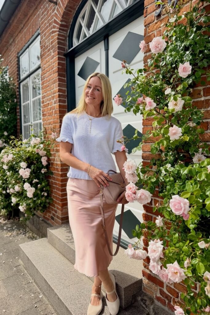 A Rose Satin Skirt With a Pale Blue Ruffled Knit Top
