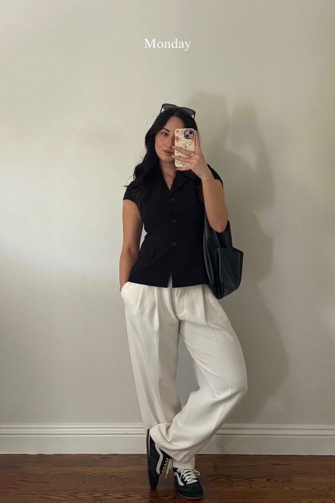 A Sleeveless Black Vest Top With Wide Cream Trousers