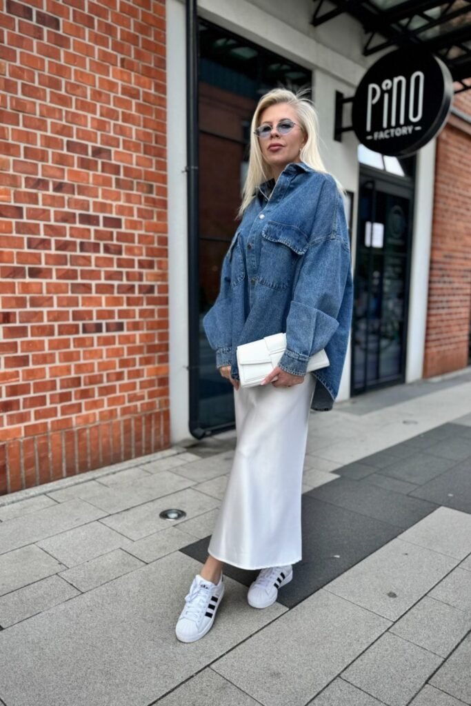 An Ivory Satin Column Skirt Under an Oversized Denim Shirt Jacket