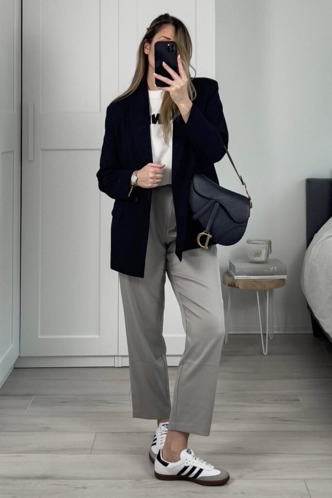 An Oversized Navy Blazer With Grey Trousers and Sambas