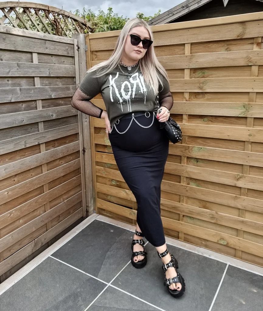 Graphic Tee Over Fishnet Sleeves With a Black Column Skirt