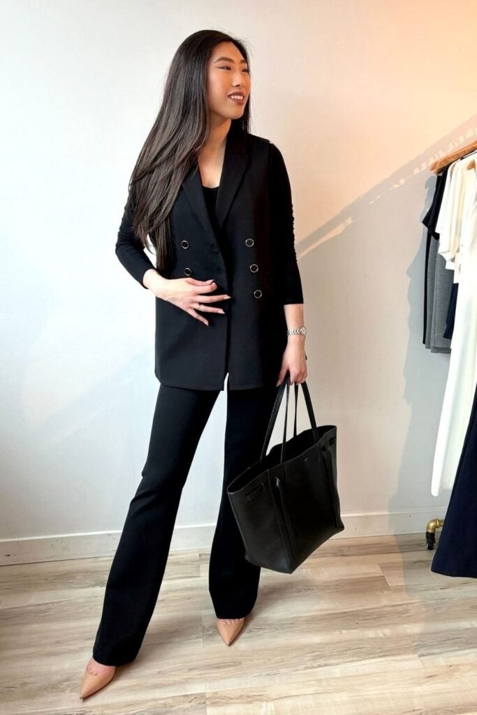 Sleeveless Black Waistcoat Over a Long Sleeve Top