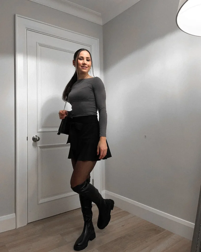 Mini Skirt With a Grey Top and Tall Boots