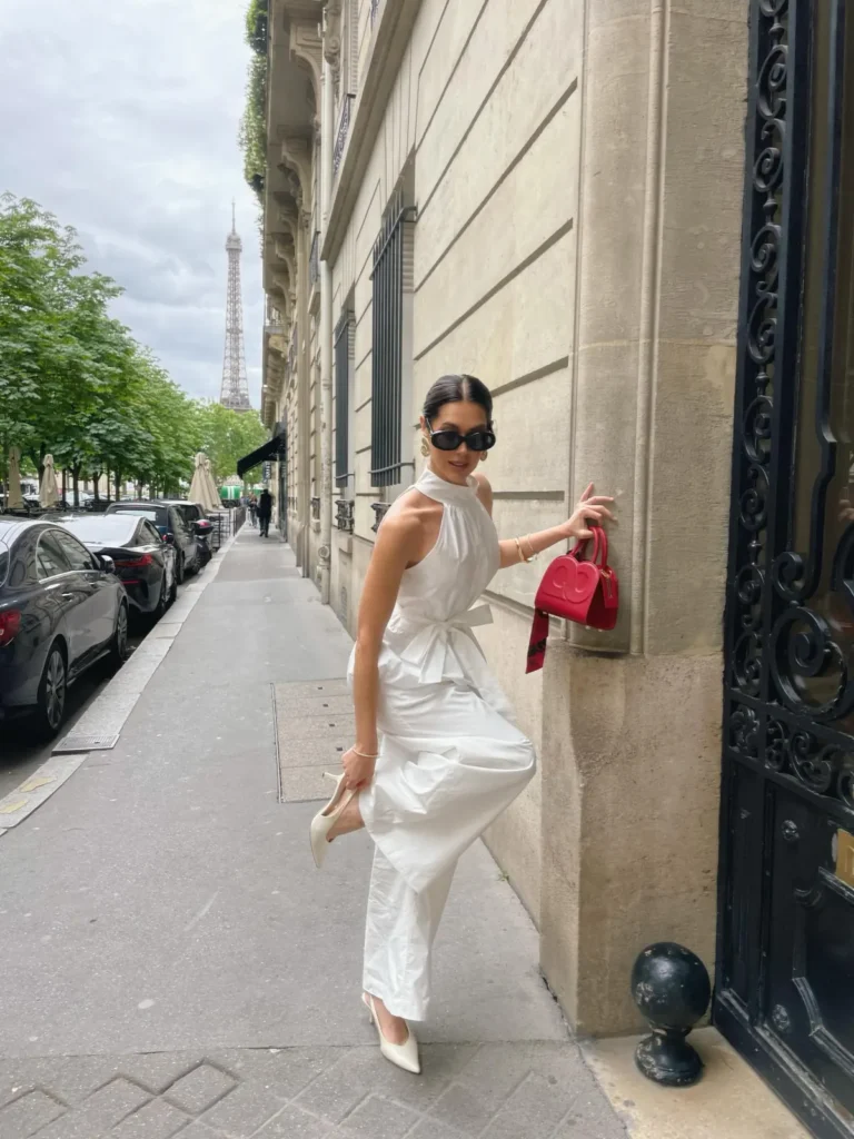 White Halter Jumpsuit With a Red Bag