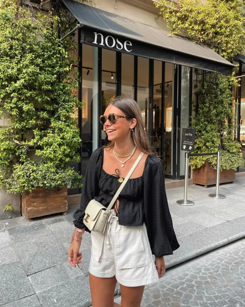 A Black Tie Front Blouse With Cream Linen Shorts
