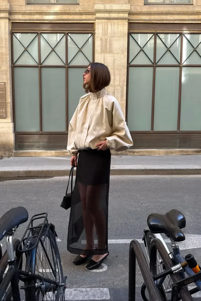 Sheer Black Maxi Skirt Under a Cream Bomber Jacket