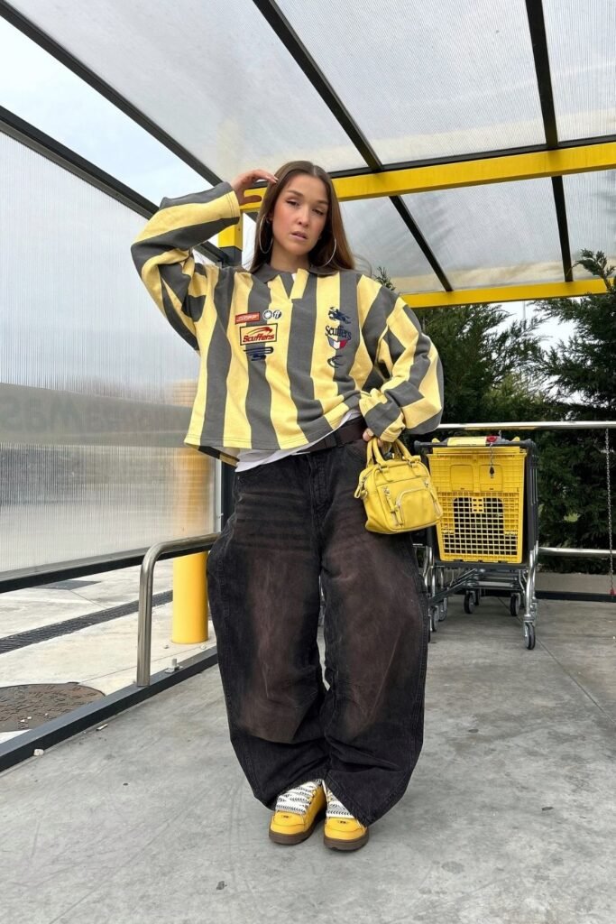 A Cropped Striped Rugby Top Over Faded Black Baggy Jeans