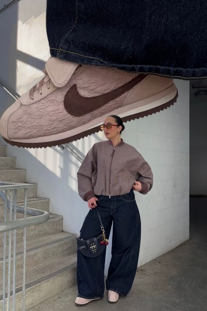 A Cropped Taupe Bomber With Dark Barrel Leg Jeans