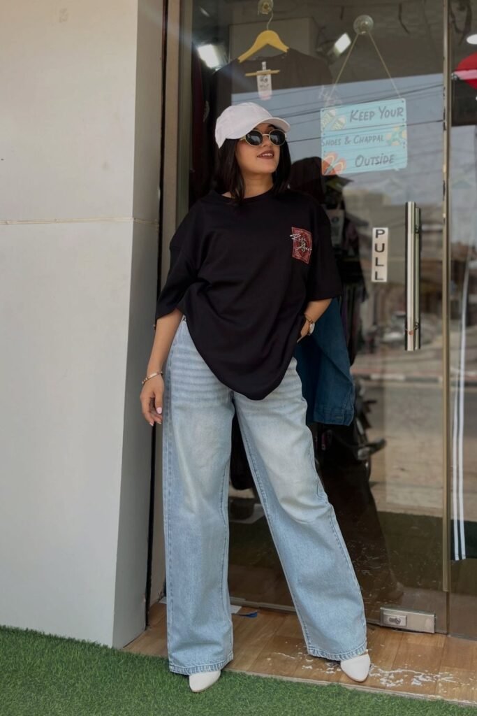 An Oversized Black Tee Over Pale Wide Leg Jeans