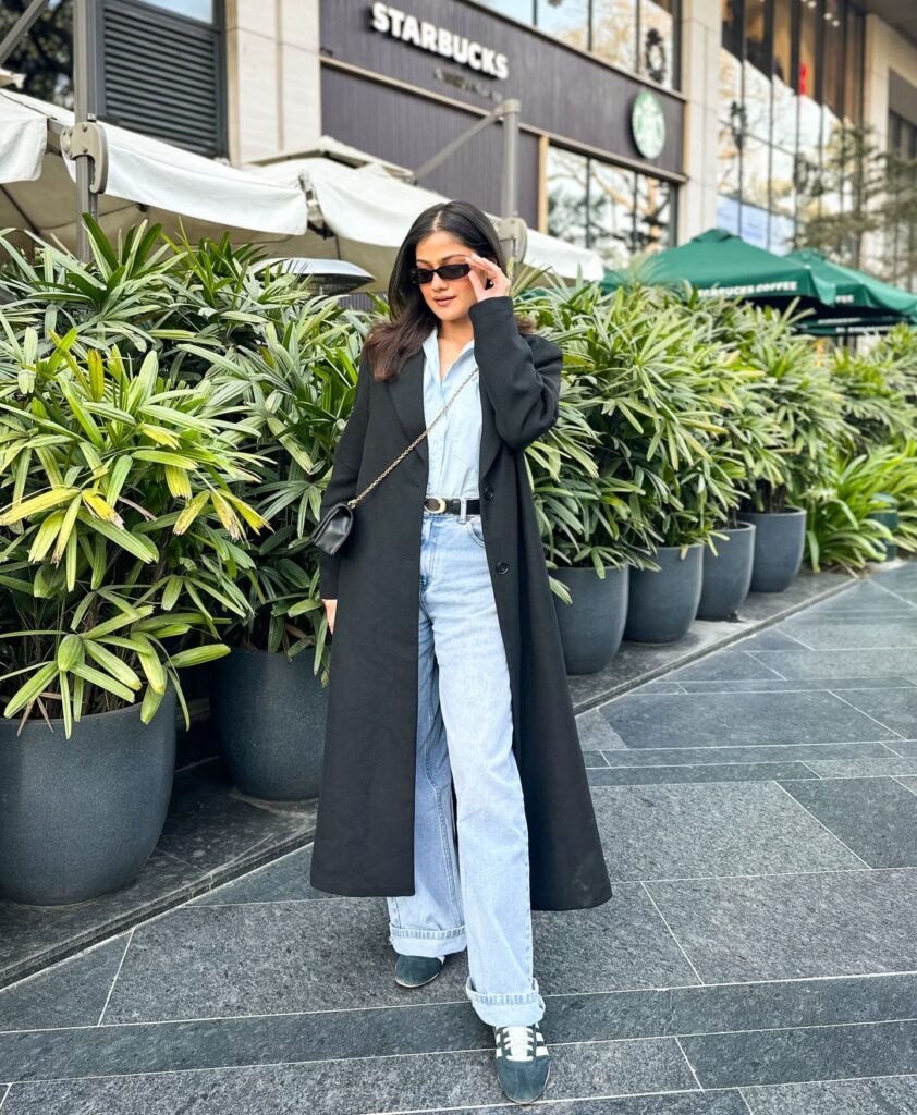 Dress Down a Long Black Trench With Pale Blue Denim