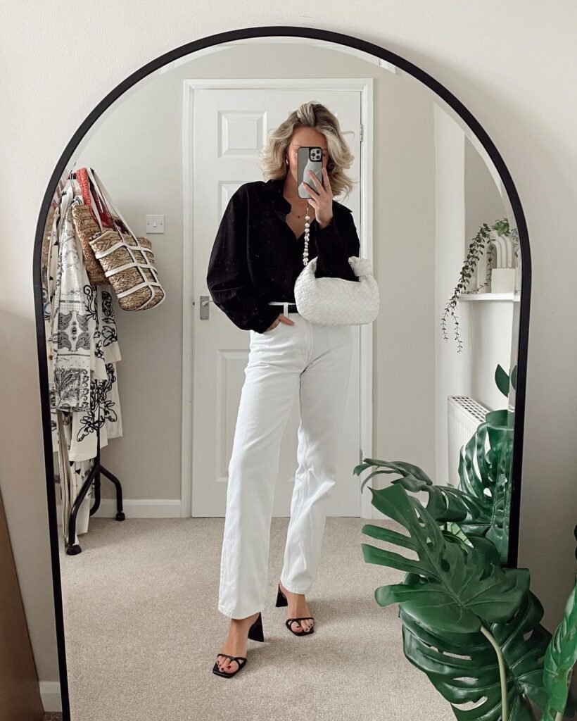 Dress Up White Jeans With a Black Blouse and Heeled Sandals