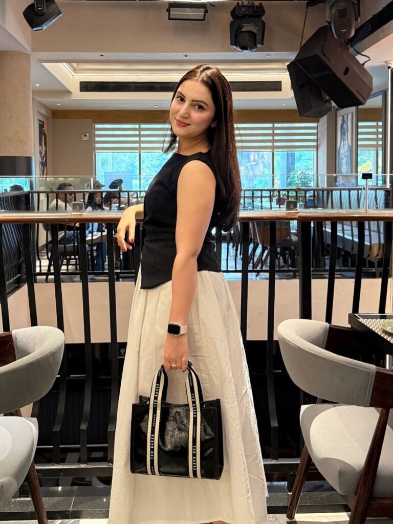 Fitted Black Peplum Top Over a Full Cream Midi Skirt