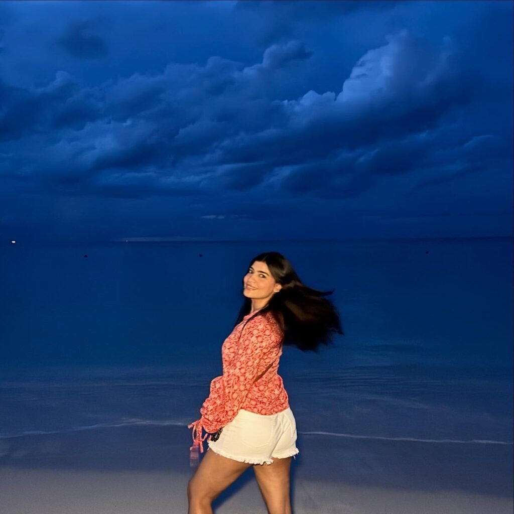 Pair a Red Printed Blouse With White Denim Shorts