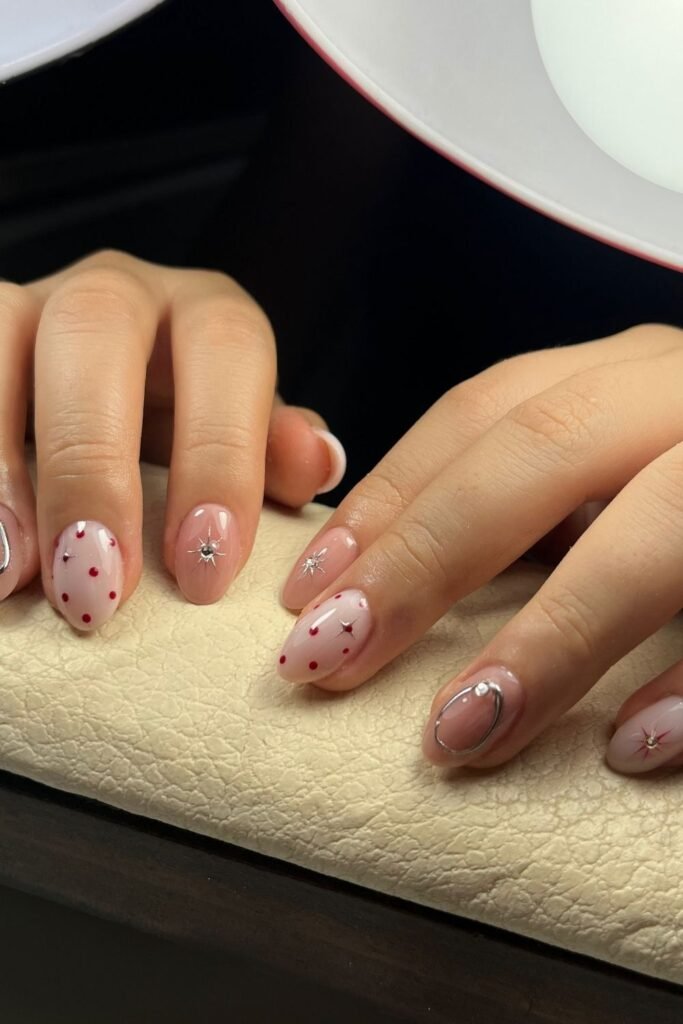 Blush Pink Starburst Nails With Tiny Red Dots