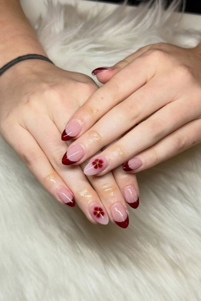 Deep Burgundy French Tips with a Matching Bloom Accent