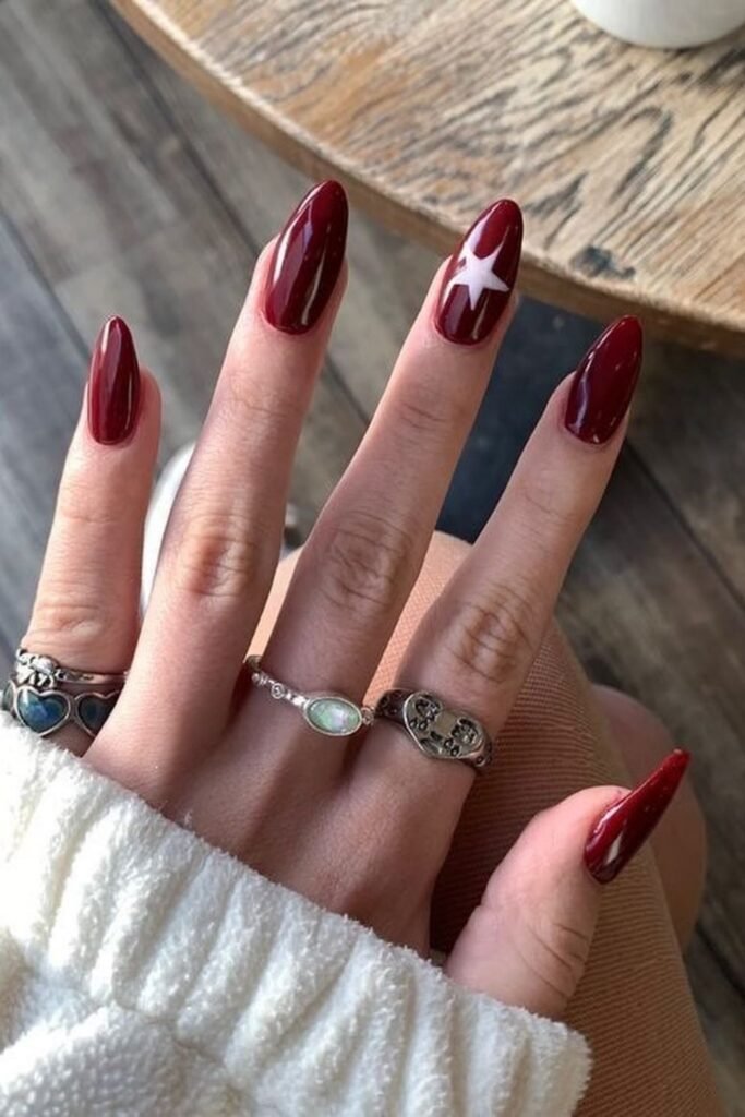 Deep Cherry Red Nails With a Single White Star