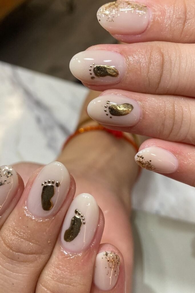 Gold Baby Footprint Nails on a Soft Nude Base