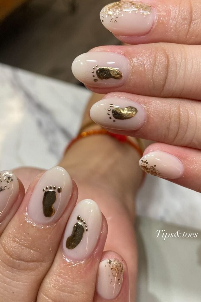 Gold Baby Footprint Nails on a Soft Nude Base