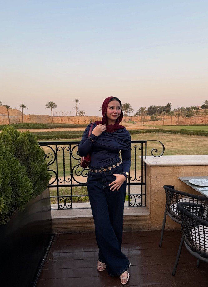 Navy Draped Top With Wide Leg Denim and a Gold Chain Belt