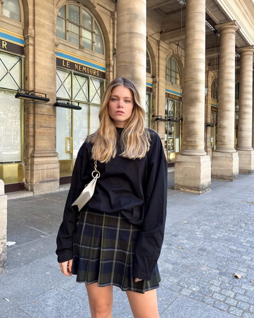 Oversized Black Sweatshirt With a Dark Plaid Skirt
