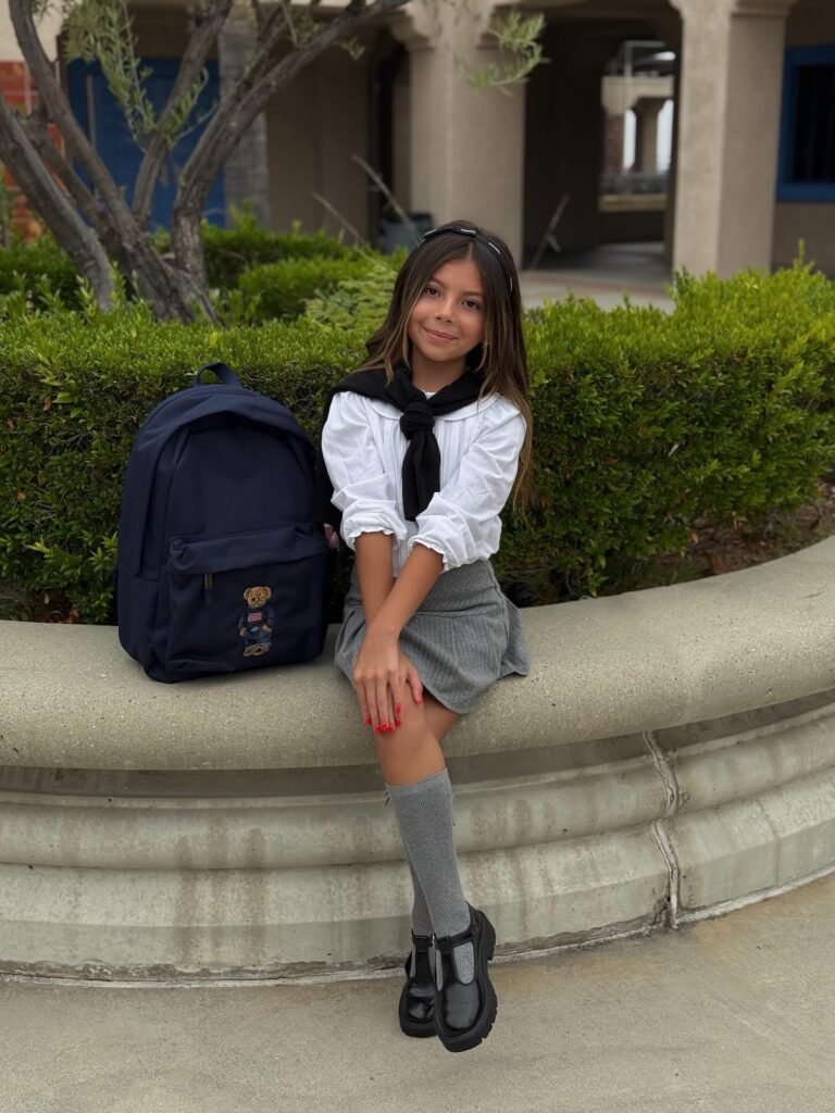 White Blouse, Gray Skirt, and Sweater Over the Shoulders