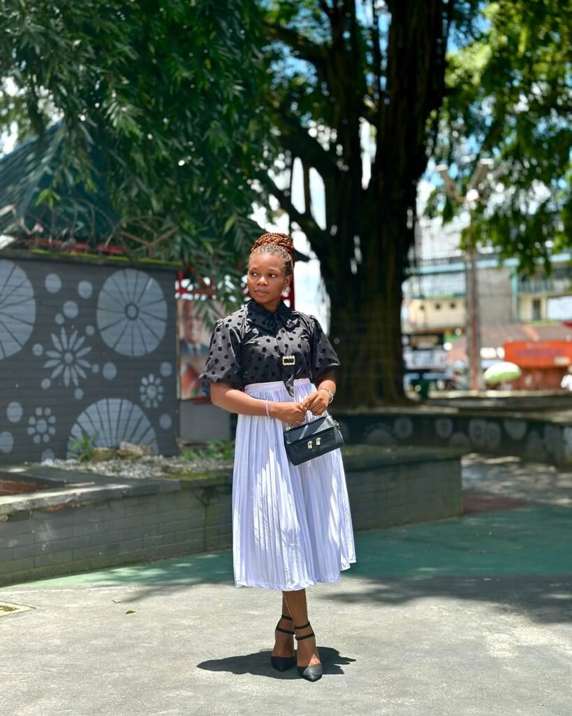 Black Polka Dot Blouse With a Pleated Midi Skirt