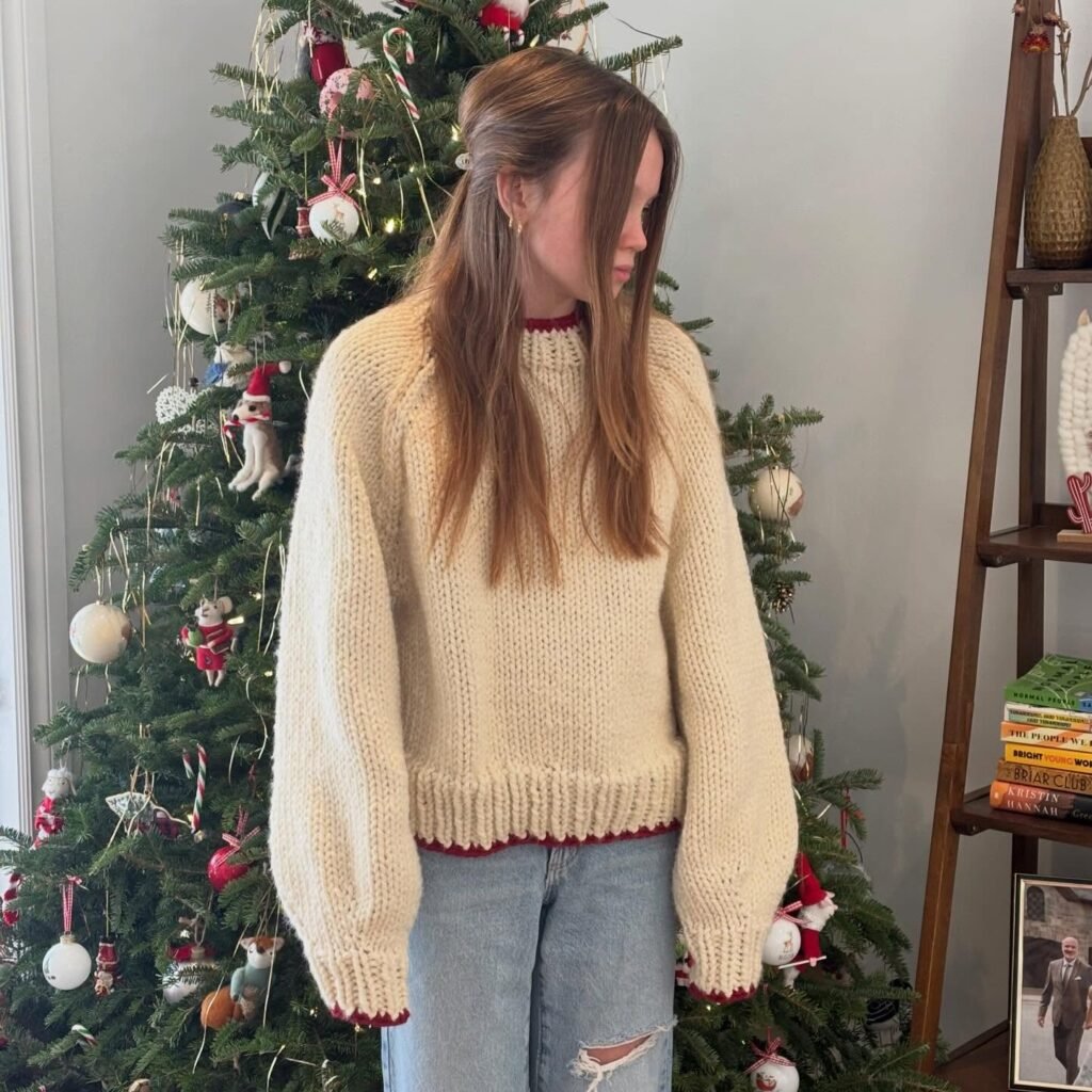 Chunky Cream Sweater With Red Trim and Light Wash Jeans