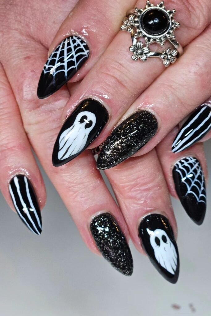 Glossy Black Ghost Nails With White Webs and Glitter