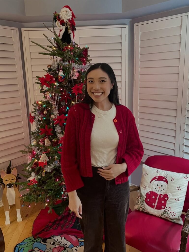 Red Cardigan Over a White Tee With Dark Trousers