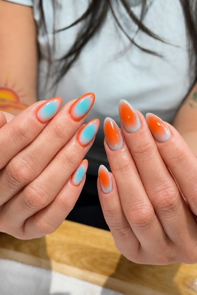 Tangerine and Baby Blue Aura on Long Almond Nails