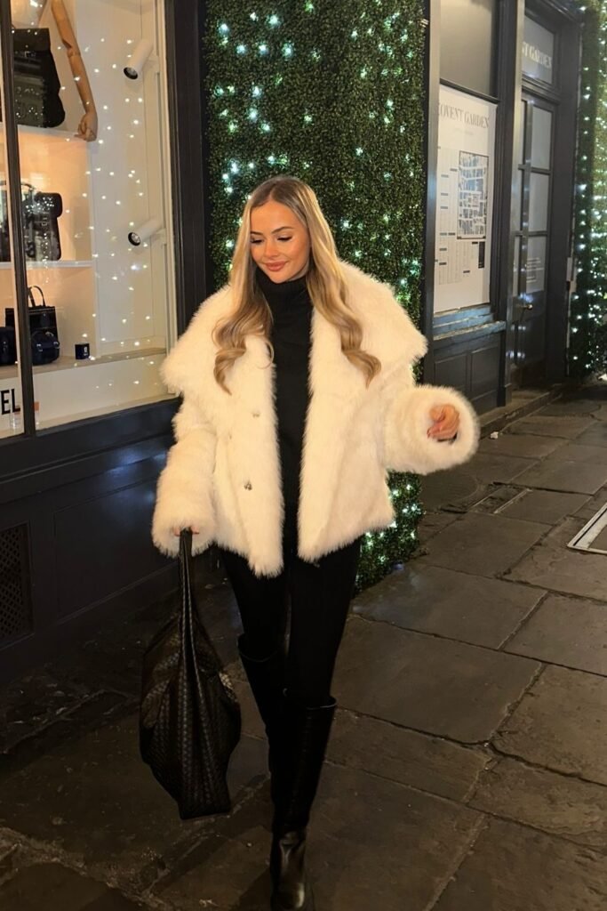 White Plush Coat Over a Sleek Black Winter Outfit