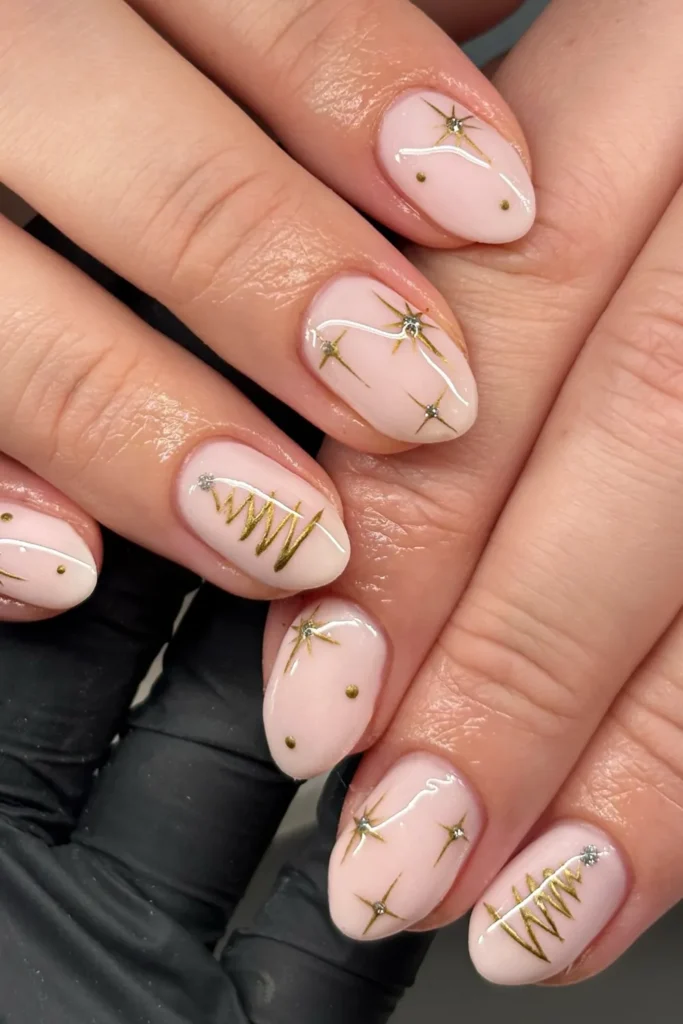 Light Pink Christmas Nails With Gold Starbursts