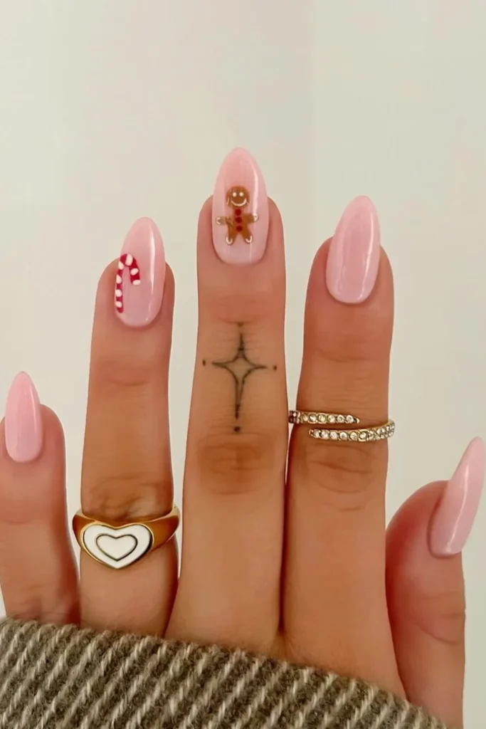 Sheer Pink Nails With a Candy Cane and Gingerbread Man